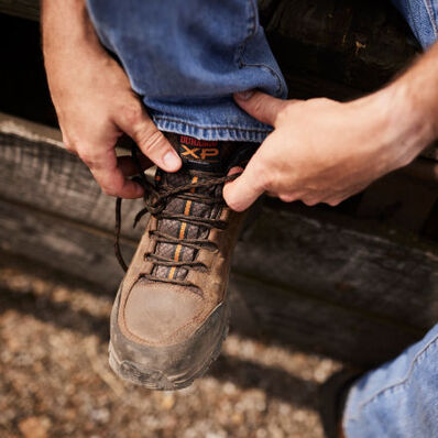 Worker lacing up Durango Renegade XP alloy toe hiker boots